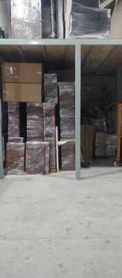 Muebles embalados apilados bajo el entrepiso, con otra carga guardada arriba