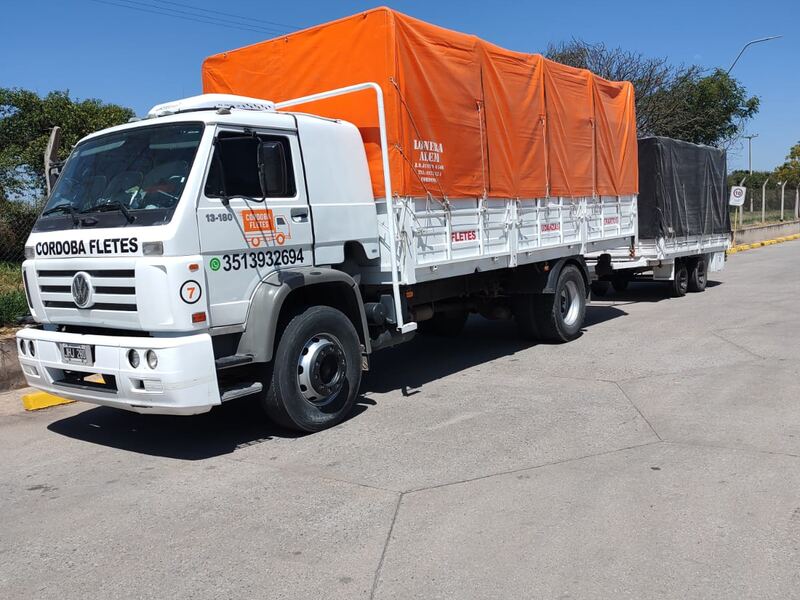 Camión con trailer de Córdoba Fletes encarpado con lona naranja